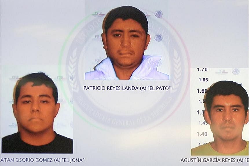 Pictures of the detainees for the case of missing students of Ayotzinapa are seen displayed on a television screen during a news conference at the Attorney General's Office building in Mexico City on Nov 7, 2014. -- PHOTO: REUTERS