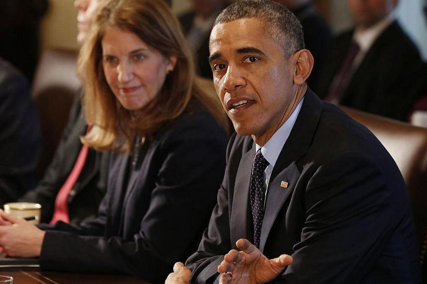 US President Barack Obama (right) speaks with Secretary of Health and Human Services Sylvia Burwell before the start of a Cabinet meeting at the White House in Washington on Nov 7, 2014. -- PHOTO: REUTERS