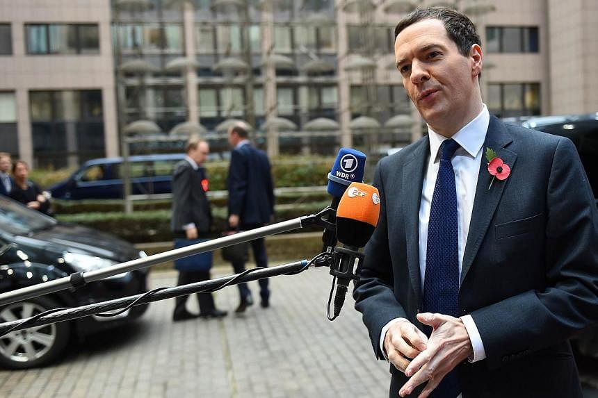 British Finance minister George Osborne talks to the press as he arrives for an economic and financial affairs meeting in Brussels on Nov 7, 2014. &nbsp;Britain claimed victory after EU finance ministers agreed Friday to extend a deadline for a huge 