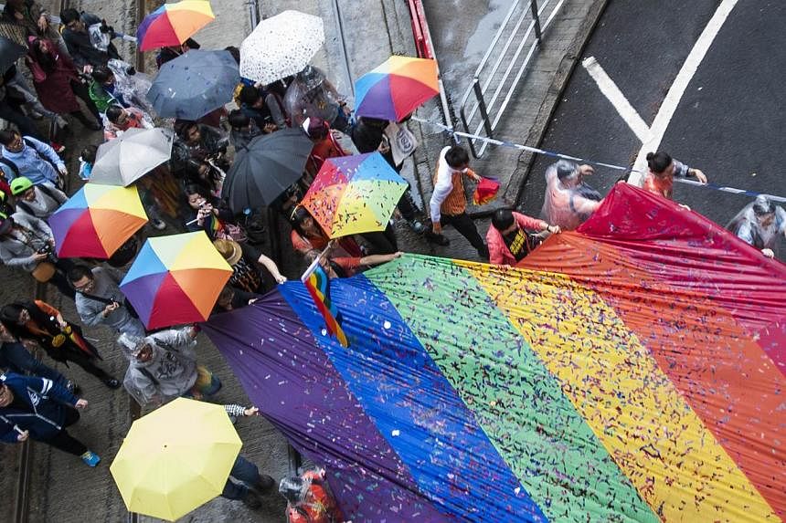 People march in Causeway Bay district during the Gay Pride Parade in Hong Kong on Nov 8, 2014. &nbsp;-- PHOTO: AFP