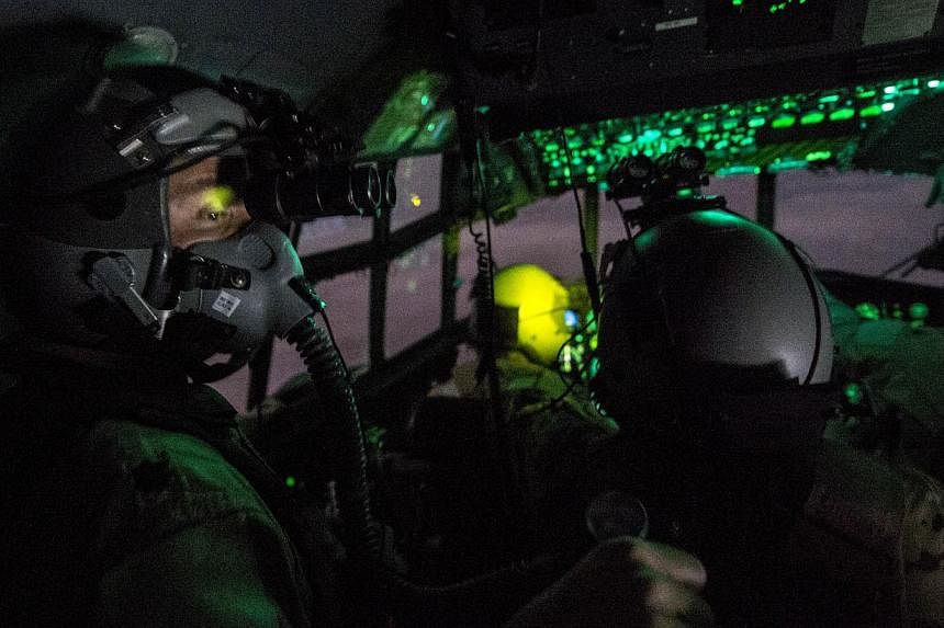 An Oct 10, 2014 US Air Force handout photo shows C-130 Hercules aircrew preparing to conduct an operational resupply airdropnear the area of Bayji, Iraq.&nbsp;President Barack Obama has approved sending up to 1,500 additional troops to Iraq to train 