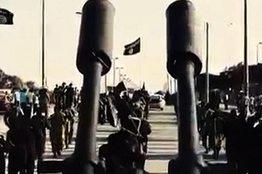 An image grab taken from a video released by Islamic State group's official Al-Raqqa site via YouTube on Sept 23, 2014, allegedly shows Islamic State in Iraq and Syria (ISIS) recruits marching in an unknown location.&nbsp;While ISIS is rapidly gainin