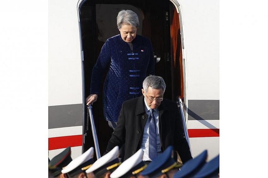 Singapore's Prime Minister Lee Hsien Loong and his wife Ho Ching arrive at the Beijing Capital International Airport Nov 9, 2014, to attend the Asia Pacific Economic Cooperation (APEC) meetings.&nbsp;-- PHOTO: REUTERS