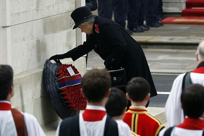 Britain's Queen Elizabeth II lays a wreath at the annual Remembrance Sunday ceremony at the Cenotaph in London Nov 9, 2014. -- PHOTO: REUTERS