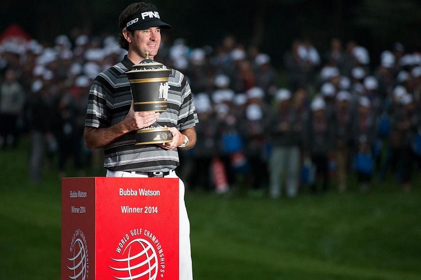 Bubba Watson of the US poses with his trophy after winning the WGC-HSBC Champions Golf tournament in Shanghai on Nov 9, 2014. -- PHOTO: AFP