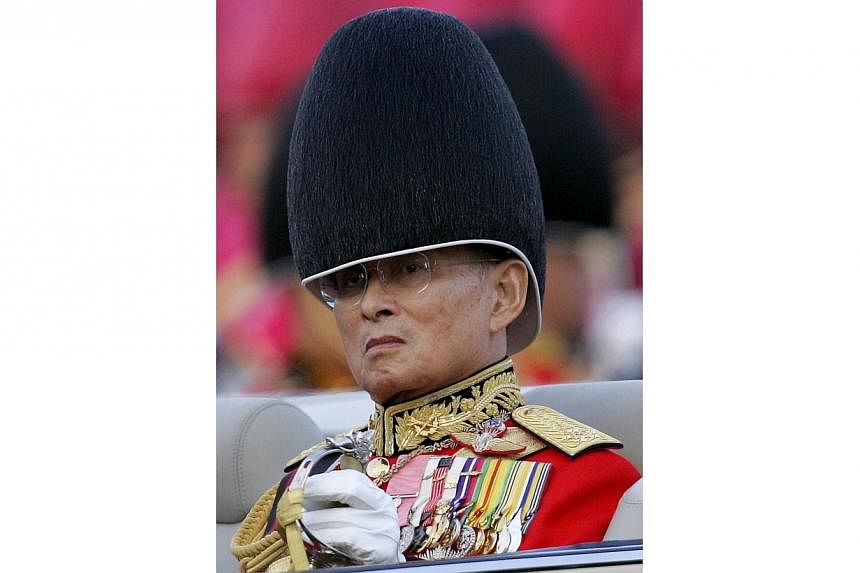 This file picture taken on Dec 2, 2007, shows Thai King Bhumibol Adulyadej reviewing an honor guard as a part of the celebration to commemorate his 80th birthday at the Royal Plaza in Bangkok.&nbsp;Thailand's revered King Bhumibol Adulyadej, the worl