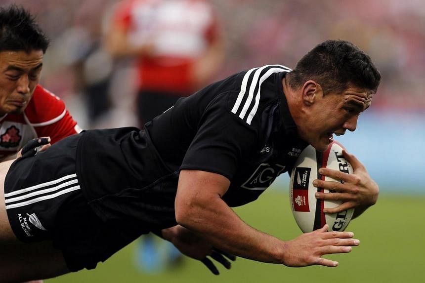 New Zealand's Maori All Blacks' Codie Taylor (right) is tackled by Japan's Ayumu Goromaru as he dives to score a try during their international rugby test match in Tokyo on Nov 8, 2014.&nbsp;The highly-anticipated match between New Zealand's Maori Al