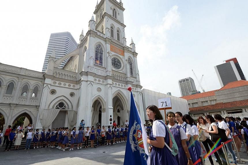 CHIJ students and alumni celebrating the schools' 160th anniversary by attempting to establish a Guiness record for a human chain of girls around Chijmes while singing the school song. A fund to help needy students was also launched at the event. -- 