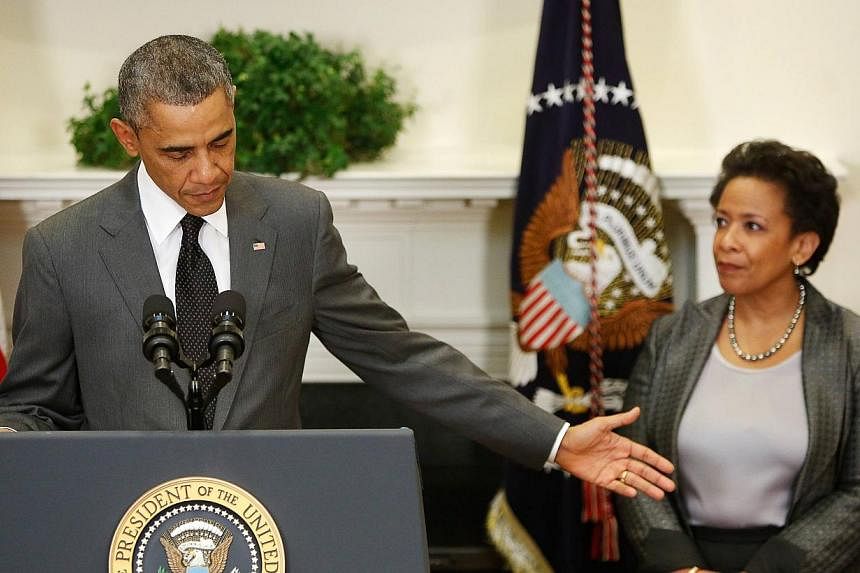 US President Barack Obama names US Attorney for the Eastern District of New York Loretta Lynch (right) to replace retiring Attorney-General Eric Holder, in the Roosevelt Room at the White House in Washington on Nov 8, 2014. Obama also took the opport