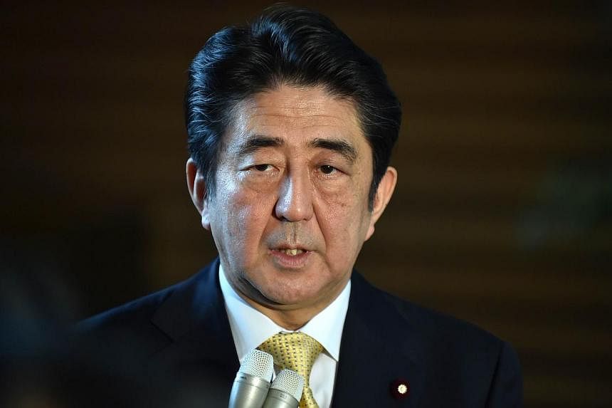 Japan's Prime Minister Shinzo Abe is considering dissolving the lower house of parliament and calling a snap election if he decides to delay a plan to raise the sales tax next year. -- PHOTO: AFP