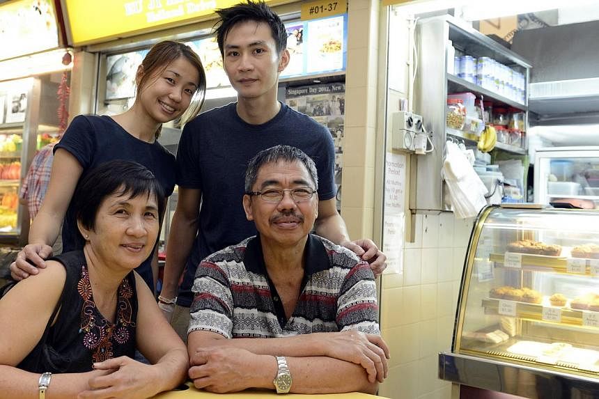 Husband and wife Daniel Lee and Joanne Ng, with Ms Ng’s parents Mr Ng Hock Loo, and Madam Lim Hua Choon. The young couple runs Ru Ji Kitchen in Old Airport Road while Mr Ng owns a fishball noodle shop of the same name in Holland Drive. -- ST PHOTO: