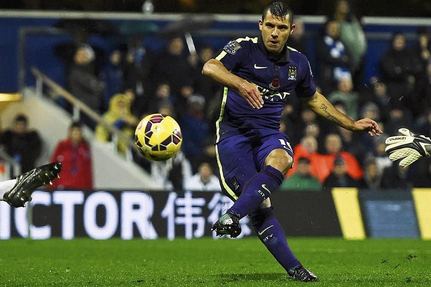Manchester City's Sergio Aguero shoots to score during their English Premier League match against Queens Park Rangers at Loftus Road in London on Nov 8, 2014. -- PHOTO: REUTERS