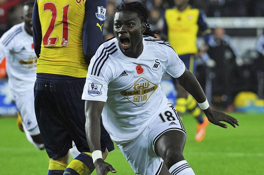 Swansea's Bafetimbi Gomis celebrates his goal during their English Premier League match against Arsenal at the Liberty Stadium in Swansea, Wales, on Nov 9, 2014. -- PHOTO: REUTERS