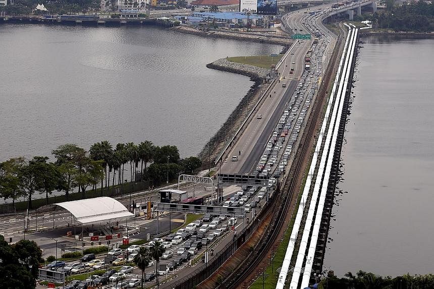 Malaysia's government revealed that 1.5 million paying vehicles crossed the Causeway in August after a toll-hike that has begun to hit Johor's economy.&nbsp;&nbsp;-- PHOTO: ST FILE