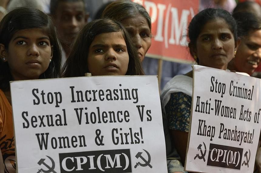In this photograph taken on Oct 30, 2012, Indian children pose with placards during a protest against sexual violence organised by the Communist party of India (Marxist) in New Delhi. -- PHOTO: AFP