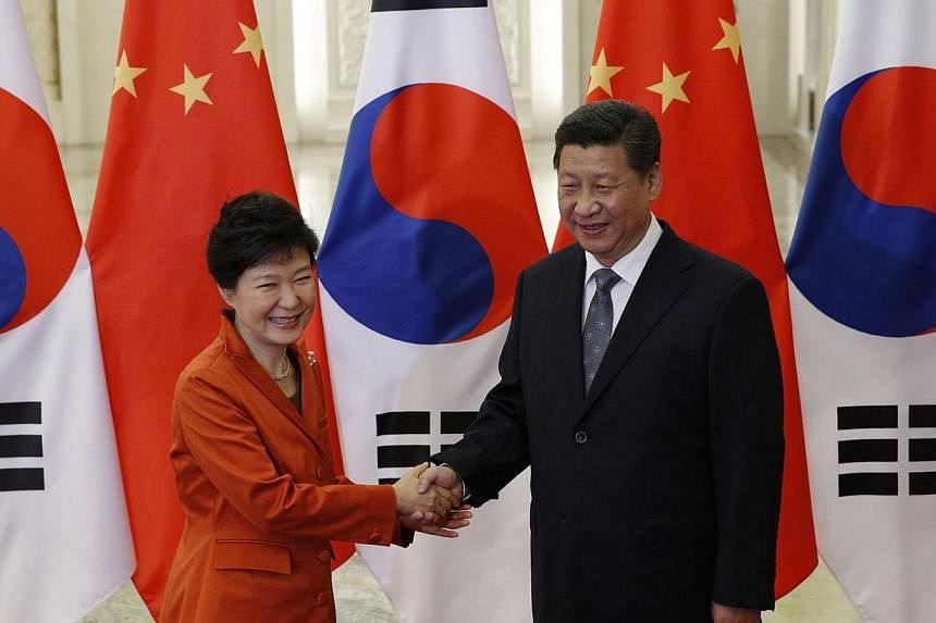 China's President Xi Jinping (right) shakes hands with South Korea's President Park Geun Hye at the Great Hall of the People on the sidelines of the Asia-Pacific Economic Cooperation (Apec) Summit in Beijing on Nov 10, 2014. -- PHOTO: AFP