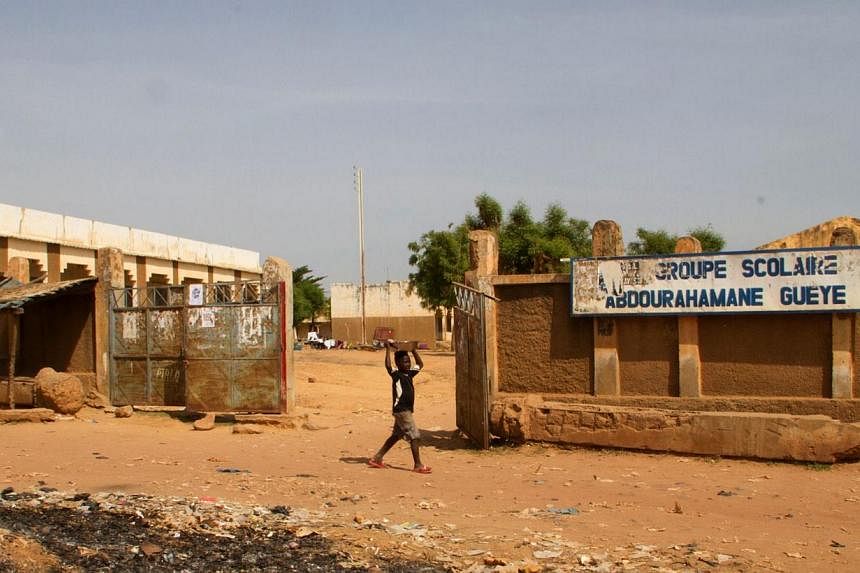 A child walks on Oct 26, 2014, past a school that was closed after the first confirmed Ebola patient in Mali died on Oct 24 in Kayes, west of the Malian capital of Bamako.&nbsp;Mali is preparing to release 108 people from Ebola quarantine in a tentat