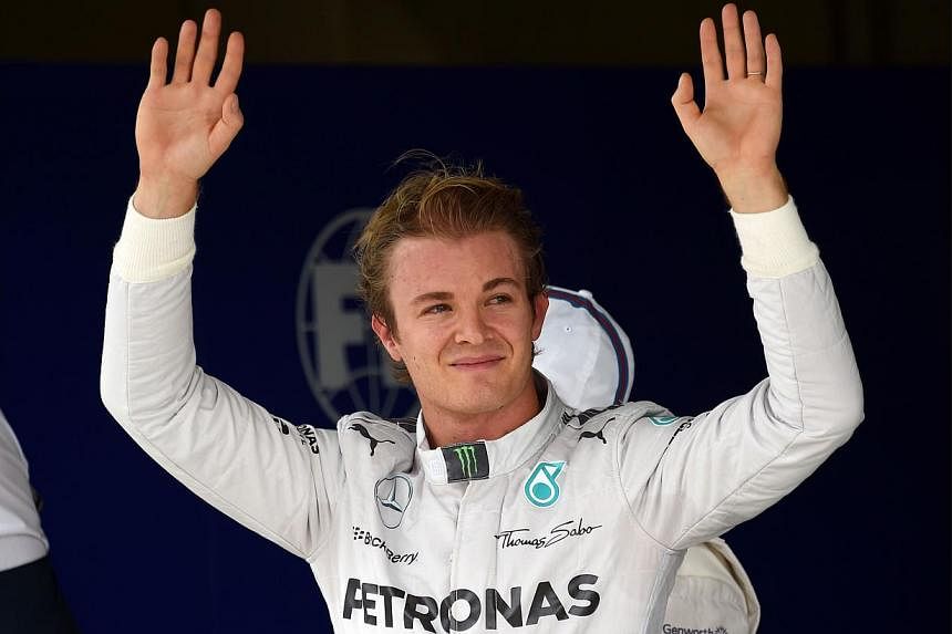 Mercedes' German driver Nico Rosberg waves after clocking the pole position for Brazil's GP tomorrow, on Nov 8, 2014, during the qualifying round at the Interlagos racetrack in Sao Paulo, Brazil.&nbsp;Nico Rosberg may need some help from his friends,