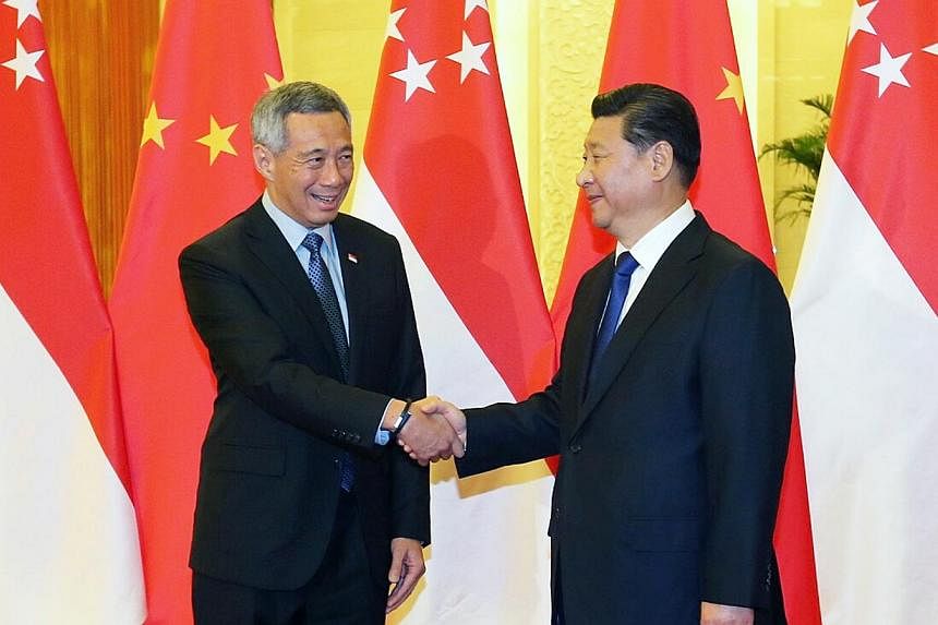 PM Lee Hsien Loong meeting Chinese President Xi Jinping at the Great Hall of the People in Beijing yesterday. Leaders of the 21-member Apec grouping are gathered in Beijing for the annual summit.