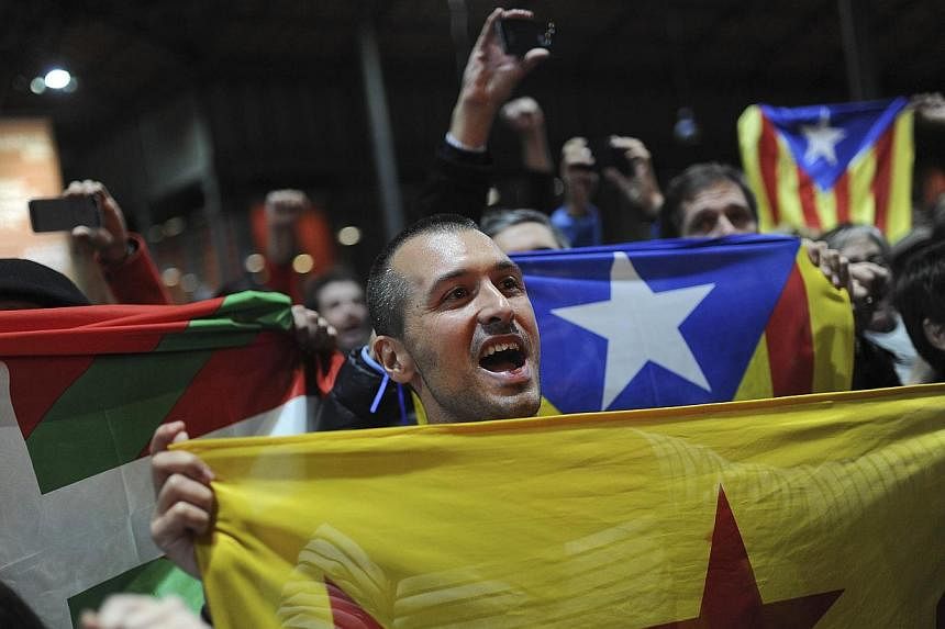 Pro-independence people hold a Catalan independence flag during a meeting organised by the Catalonia National Assembly (ANC) and the Omnium Cultural civil society association in Barcelona on Nov 9, 2014.&nbsp;Catalonia's nationalist government vowed 