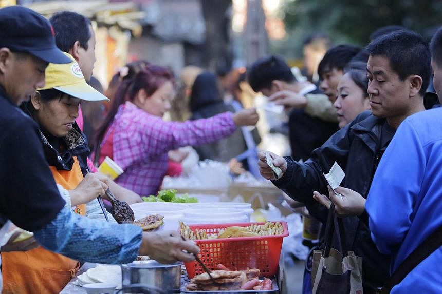 China's annual consumer inflation remained at a near five-year low in Oct 2014 at 1.6 per cent, showing proof that the world's second-largest economy is cooling and giving room to policymakers to stimulate growth if needed. -- PHOTO: REUTERS&nbsp;