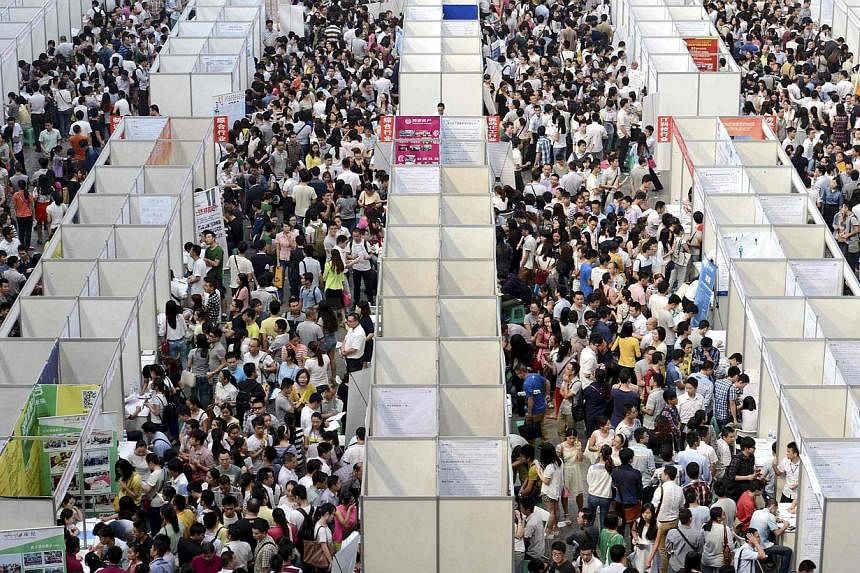 Thousands of job seekers visit booths at a job fair in China's Chongqing municipality. -- PHOTO: REUTERS