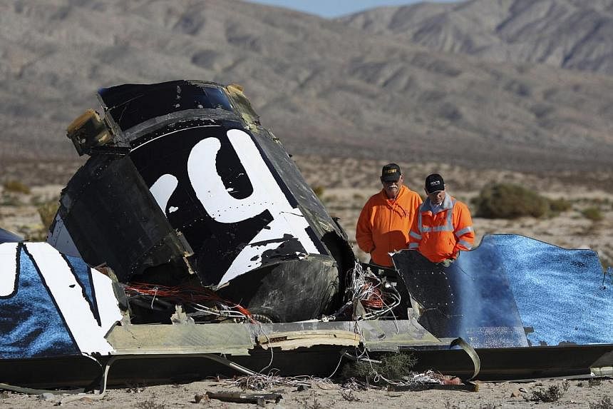 Sheriffs' deputies look at wreckage from the crash of Virgin Galactic's SpaceShipTwo near Cantil, California on Nov 2, 2014. -- PHOTO: REUTERS