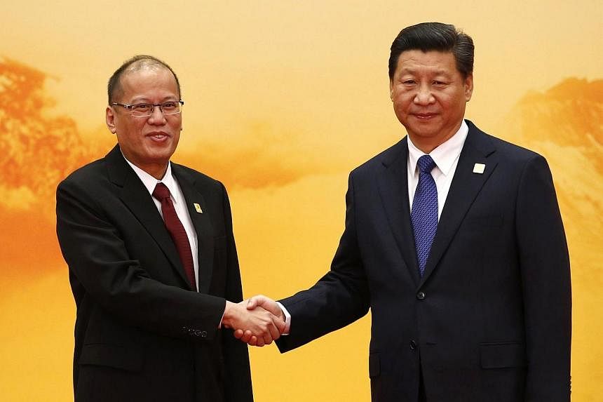 Philippine President Benigno Aquino (left) shakes hands with China's President Xi Jinping during a welcoming ceremony at the Asia Pacific Economic Cooperation (APEC) forum, at the International Convention Center at Yanqi Lake, in Huairou district of 