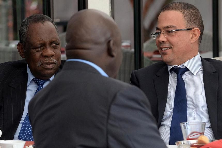 Issa Hayatou (left), Confederation of African Football (CAF) president, speaks to Fouzi Lekjaa (right), president of the Moroccan Football Federation (FRMF), during breakfast on Nov 3, 2014 in Rabat, Morocco.&nbsp;The north African nation was officia