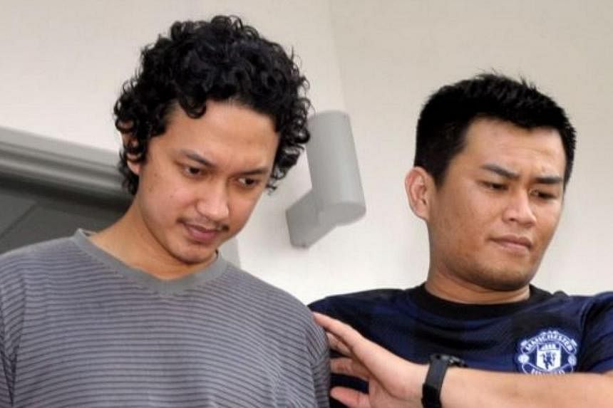 Cake shop assistant Mohammad Na'im Abd Rashid being led out of the court room on Tuesday. Mohammad Na'im was one of three men charged for allegedly supporting the Islamic State in Iraq and Syria (ISIS). -- PHOTO: THE STAR/ASIA NEWS NETWORK