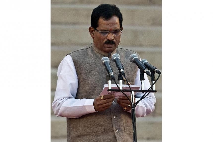 Indian Cabinet Minister Shripad Yesso Naik takes an oath of office during the swearing-in ceremony at The Presidential Palace in New Delhi on May 26, 2014. -- PHOTO: AFP