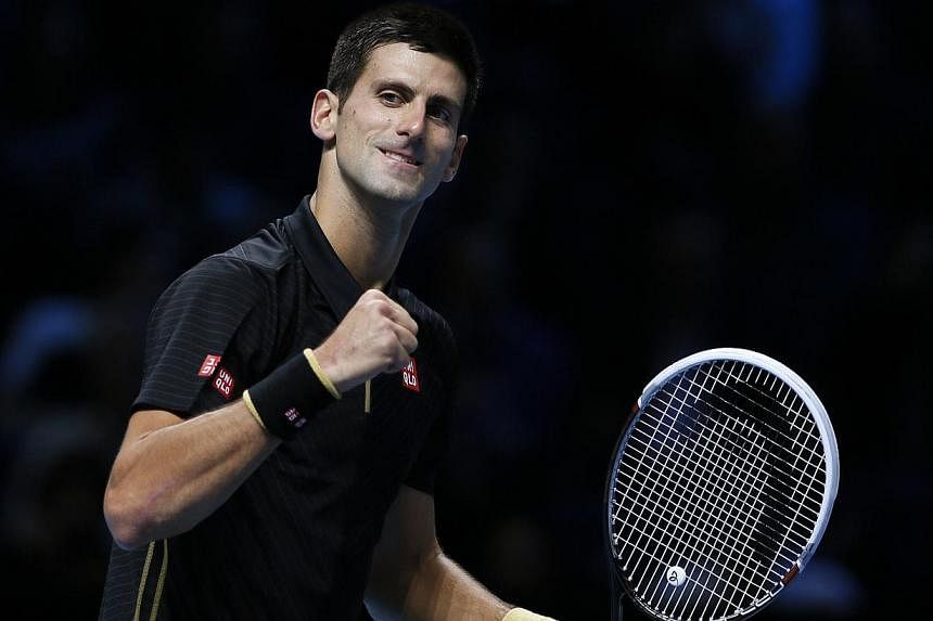 Novak Djokovic of Serbia celebrates after winning his tennis match against Marin Cilic of Croatia at the ATP World Tour finals at the O2 Arena in London on Nov 10, 2014. -- PHOTO: REUTERS