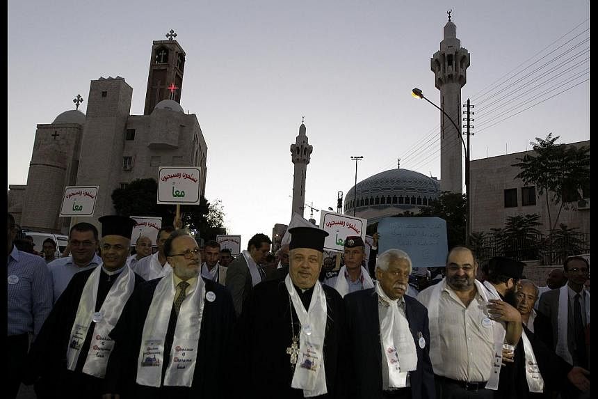 Jordanian Christians and Muslims marching together in Amman in August, to condemn religious hatred. A proper approach to studying Quranic texts and Islamic history shows tolerance of non-Muslims was the norm.