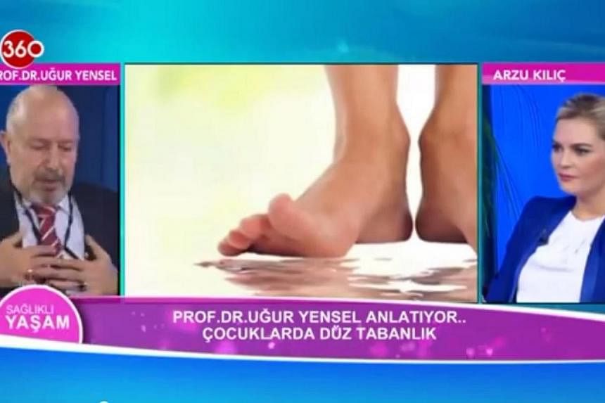 A screenshot from YouTube shows Dr Ugur Yansel clutching his chest. Dr Ugur Yansel, a professor of orthopaedics, was explaining flat feet in children when he had a heart attack during a live telecast of the hugely-popular Healthy Living (Saglikli Yas