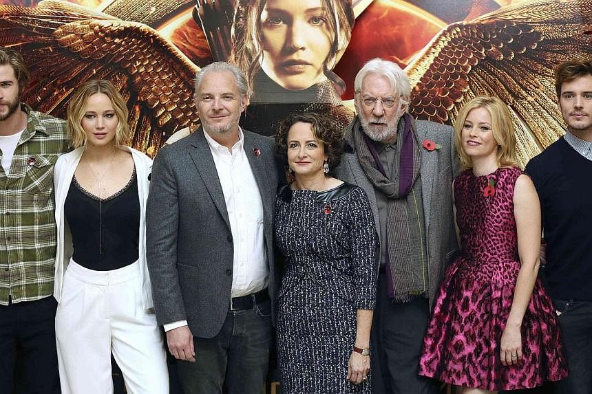 (From left) Cast members Liam Hemsworth, Jennifer Lawrence, director Francis Lawrence, producer Nina Jacobson, cast members Donald Sutherland, Elizabeth Banks and Sam Claflin attend the photocall for 'The Hunger Games: Mockingjay Part 1', in London o