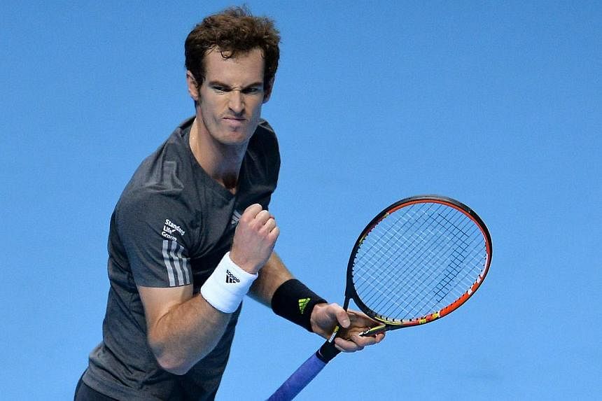 Britain's Andy Murray celebrates match point against Canada's Milos Raonic during their Group B singles match on day three of the ATP World Tour Finals tennis tournament in London on Nov 11, 2014. -- PHOTO: AFP