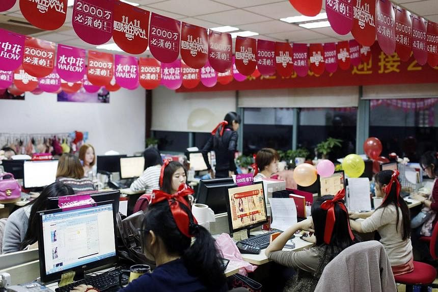 Employees of Tmall, which sells underwear on Alibaba, work online to serve customers and deal with orders overnight in Hangzhou, China. -- PHOTO: REUTERS