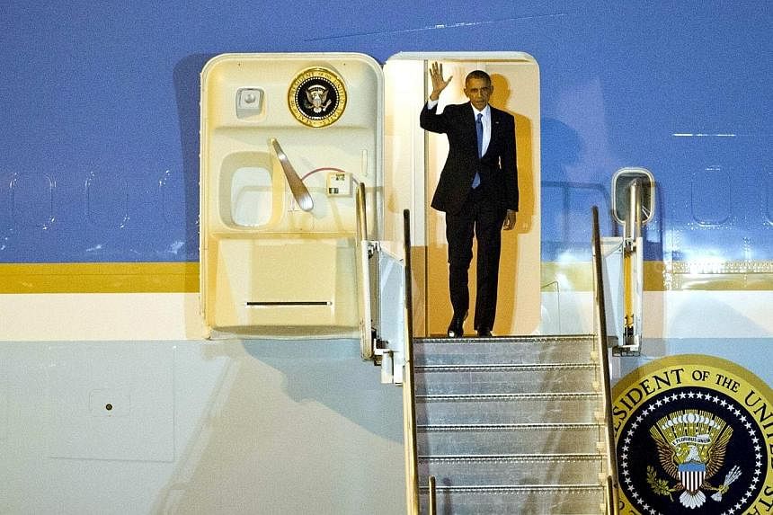 US President Barack Obama waves as he arrives in Naypyidaw International Airport in Myanmar on Nov 12, 2014,&nbsp;as part of a hectic series of summits across the Asia-Pacific. -- PHOTO: AFP