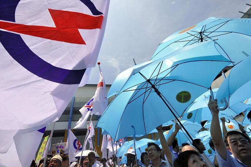 Supporters of the PAP (left) and WP on Nomination Day in 2011. The next GE will almost certainly be a straight fight between the two parties, providing some indication of whether Singapore is evolving from a one-party dominant to a two-party politica