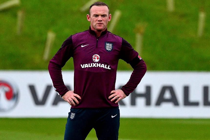 England 's Wayne Rooney takes part in a training session at St George's Park near Burton-on-Trent, central England, on Nov 11, 2014. -- PHOTO: AFP