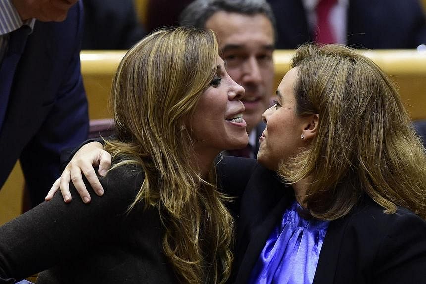 Vice-President of the Government Soraya Saenz de Santamaria (right) kisses president of the Popular Party in Catalonia Alicia Sanchez Camacho at the senate in Madrid on Nov 11, 2014. Spain's government said today it was "not possible" to grant the Ca