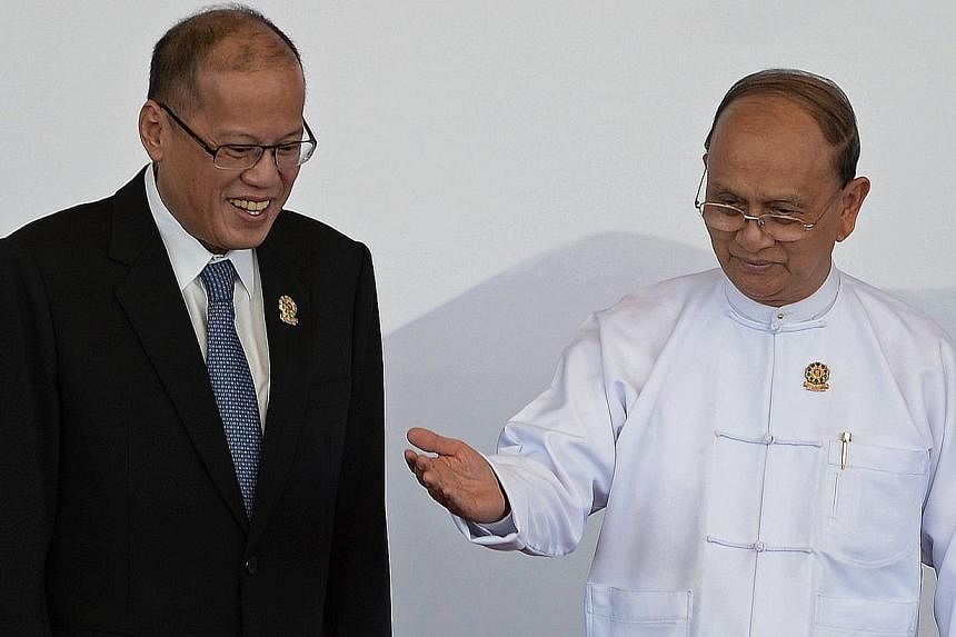 Myanmar President Thein Sein (right) gestures after welcoming Philippines's President Benigno Aquino ahead of the 25th Asean Summit at the Myanmar International Convention Centre in Myanmar's capital Naypyidaw on Nov 12, 2014. -- PHOTO: AFP