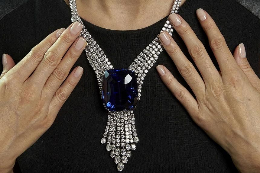 A Swiss auction has set a new world record for jewellery sales, Christie's said on Wednesday, led by a Ceylon sapphire known as the "Blue Belle of Asia" that alone sold for an unprecedented 16.96 million Swiss francs (S$22.7 million). -- PHOTO: REUTE