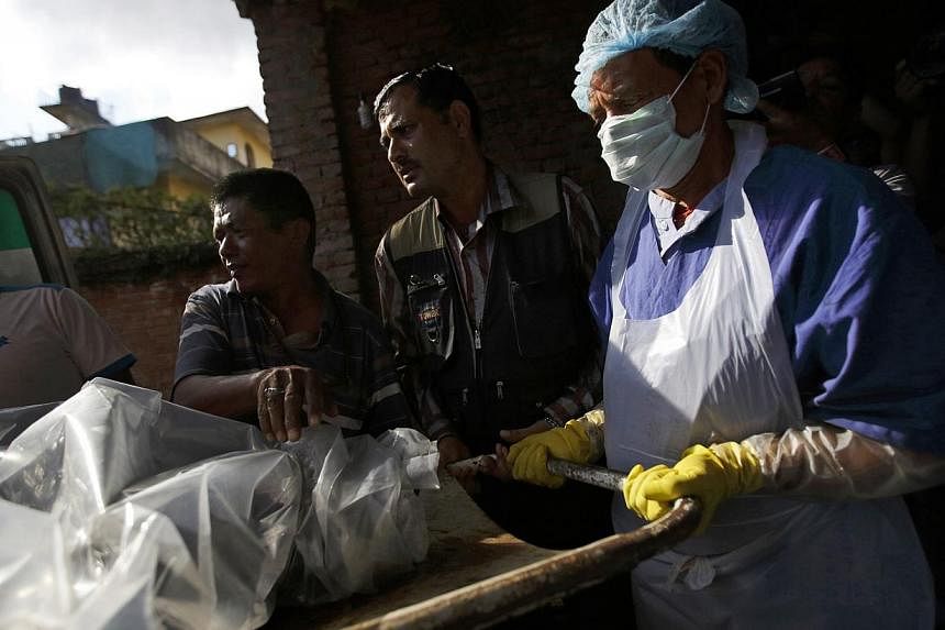 The body of a victim is moved into a morgue after it was brought back from the Annapurna Region in Kathmandu on Oct 17, 2014.&nbsp;Nepalese rescuers have retrieved the body of a Canadian woman who died in the massive snowstorm that claimed 43 lives i