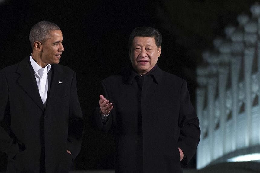 US President Barack Obama (left) walks with China's President Xi Jinping at the Zongnanhai leaders compound, ahead of a dinner in Beijing on Nov 11, 2014. The United States and China are planning to announce military agreements aimed at reducing the 