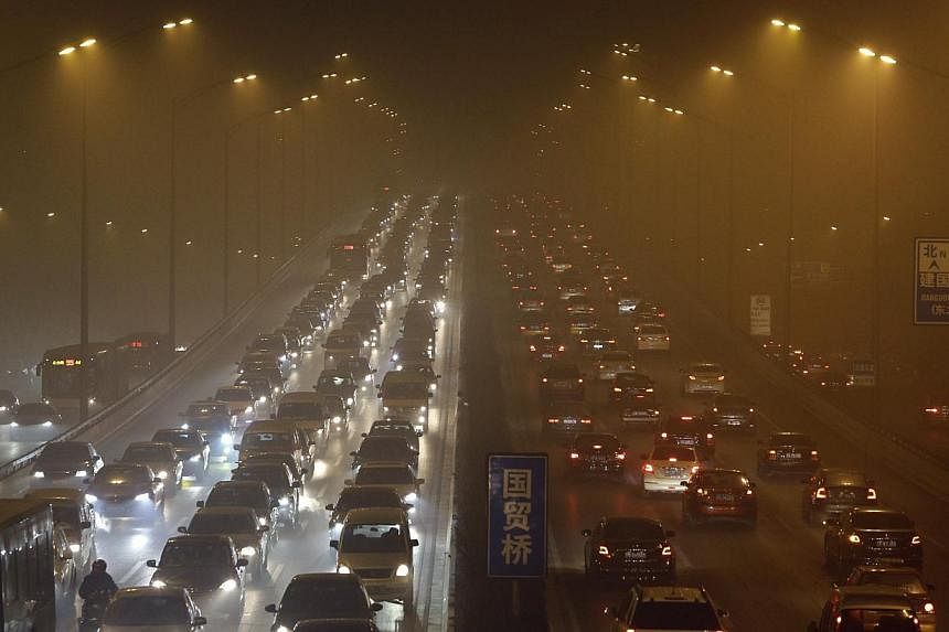Vehicles on the Third Ring Road on a hazy winter day in Beijing in 2013. China has agreed a target for its emissions of greenhouse gases to peak by "around 2030", the White House said Wednesday as United States President Barack Obama met Xi Jinping f