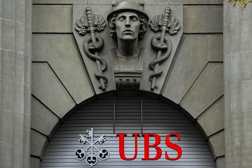 A file photo taken on October 15, 2011 shows the logo of the Swiss banking giant UBS seen above its headquarters in downtown Zurich. -- PHOTO: AFP