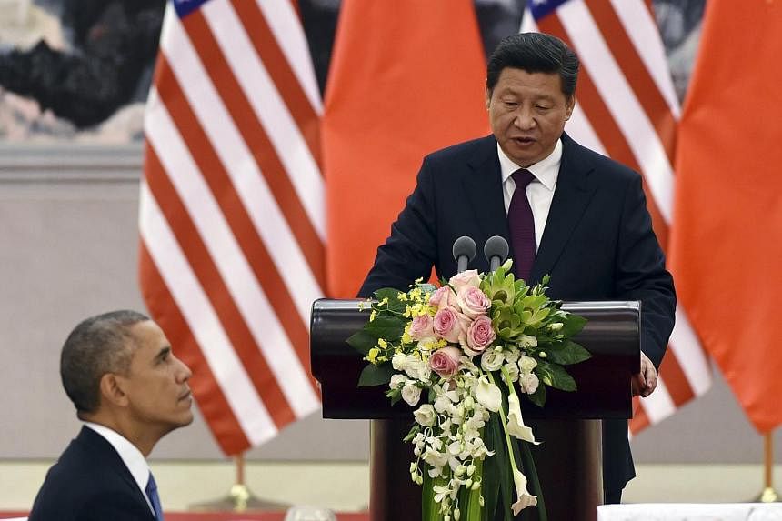 Chinese President Xi Jinping speaks at a lunch banquet with US President Barack Obama (left) in the Great Hall of the People in Beijing, China on Nov 12, 2014. -- PHOTO: REUTERS