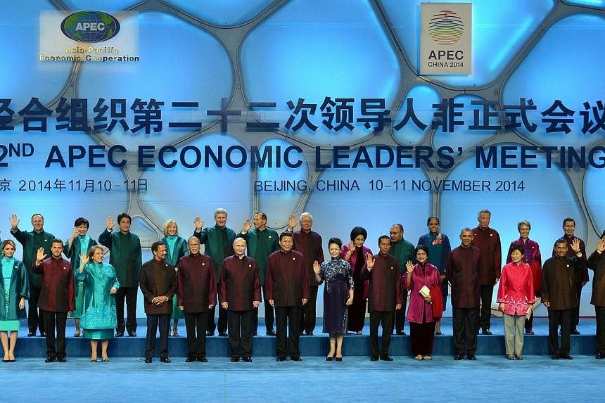 This file photo taken on Nov 10, 2014 shows leaders and their spouses of the Asia-Pacific Economic Cooperation (Apec) economies posing for a "family photo" at the Beijing National Aquatics Center in the Chinese capital.&nbsp;Chinese traders are offer