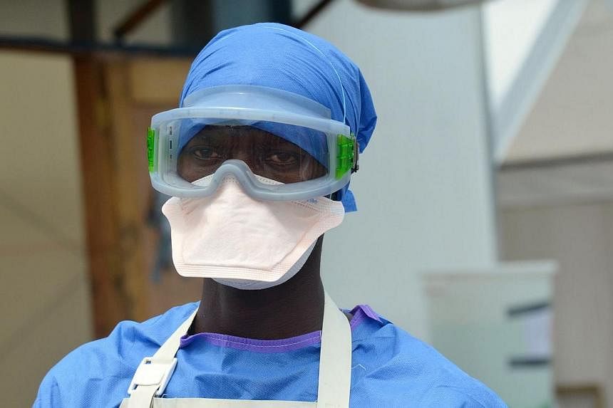 Health worker Mark Jerry, 36, stands on Nov 1, 2014 at the clinic run by the non-governmental organization Doctors Without Border (MSF) in Monrovia, Liberia. MSF said Thursday it would launch clinical trials of three possible treatments for Ebola in 